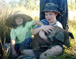 The Seiler children with one of Bottle Tree Hill's organically-raised piglets